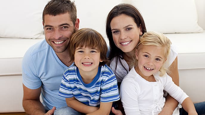 Portrait Of Happy Family Smiling In Living-room